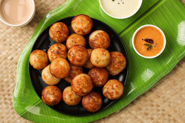 Paniyaram, Kuzhi paniyaram Gunta ponganalu paddu, guliyappa made of black lentils and rice deep fried snack or breakfast vegan vegetarian South Indian Kerala Tamil Nadu Karnataka Sri Lanka Lankan food