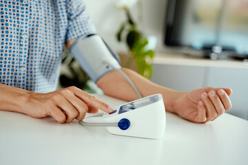 measuring his blood pressure at home - obrazy, fototapety, plakaty