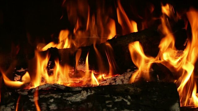 Close up of a logs burning in a fireplace