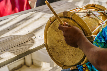 Dominican Republic. The beach musician plays the drum. Drummer. Close-up of a hand and a drum. Dominican people.