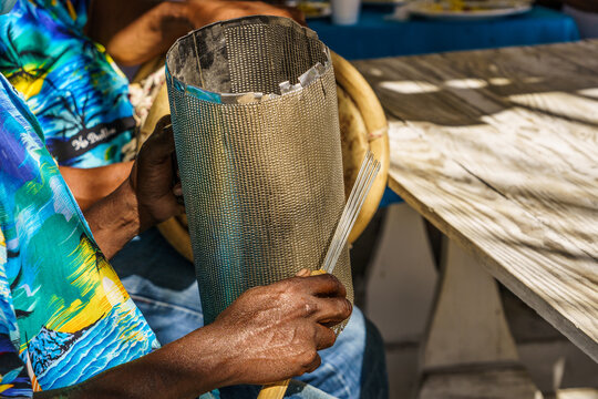 Dominican Republic. Beach Musician Merengue. Close-up Of A Hand And A Musical Instrument. Dominican People.