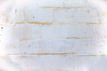 Old whitewashed brick wall in gray with a white tint.