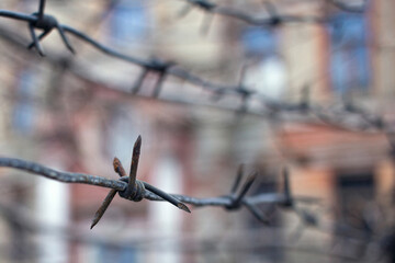 rusty barbed wire on blurred background