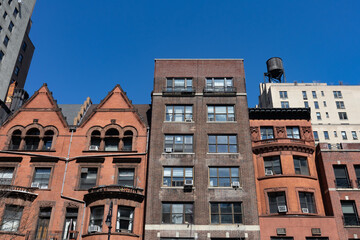 Row of Colorful Old Brownstone Homes and Residential Buildings on the Upper West Side of New York...