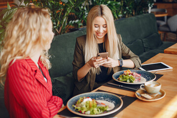 Two businesswomen working in a cafe