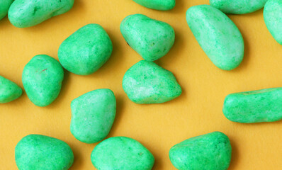 green pebbles on yellow background