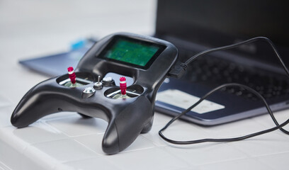 The joystick for computer games lies on the surface of a white color. The concept of gaming, new information technologies and game consoles.