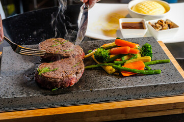 Steak cooked on lava-stone.