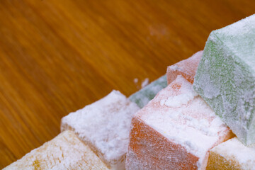 Close up view of the Turkish Delights on the wooden plate. Ramazan bayrami (eid al fitr) and Kurban bayrami (eid al adha) background photo. Turkish delight (lokum). Eid mubarak - iyi bayramlar