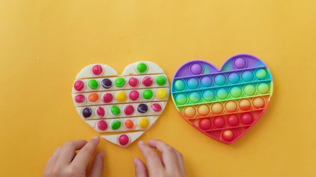 Use the popular pop it toy as a chocolate mold. White chocolate and colorful candies. DIY concept. Step-by-step photo instructions. 
