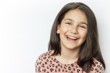 Portrait of a happy laughing kid girl on white background