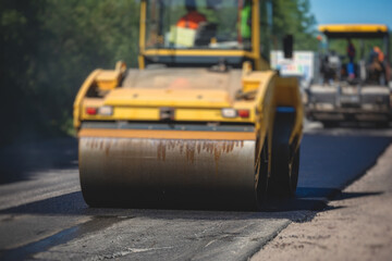 Process of asphalting and paving, asphalt paver machine and steam road roller during road...