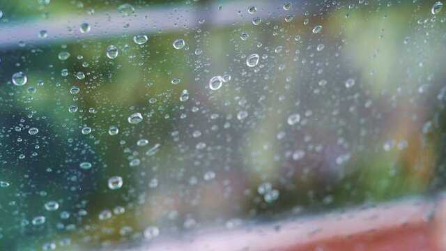 Rainy day behing the window in 4k slow motion 60fps