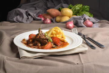 stewed beef steak in marinated sauce with French fries and vegetables hotel restaurant Peruvian cuisine halal cafe menu