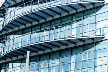 The facade of the glass building with semicircular balconies.