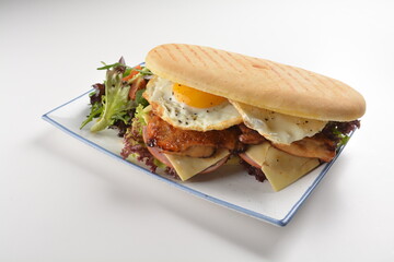 assorted sandwiches club with focaccia bread, grilled teriyaki chicken , cheese and fried egg with salad in white background western halal menu