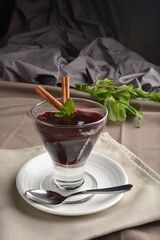chilled raspberry jelly pudding dessert in glass with cinnamon stick and mint leaf Peruvian cuisine menu