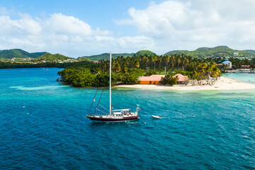 Sailing boat enters the bay of Martinique French Polynesia.