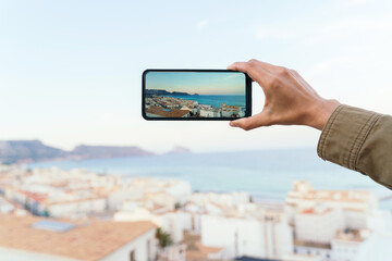 Panoramic view of phone screen with travel destination. Holidays background and technology concept