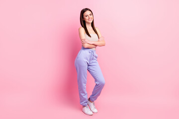 Fototapeta na wymiar Full length body size view of attractive content cheerful girl posing folded arms isolated over pink pastel color background