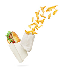 Burger and baked potatoes in the wrapping paper close-up on white background