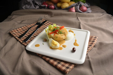 boiled egg with potato salad and dressing in square plate appetiser Peruvian cuisine menu