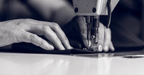 man working on a sewing machine. without a face.