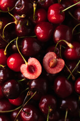 the cherry is close. a cut cherry berry with cuttings on top of other berries