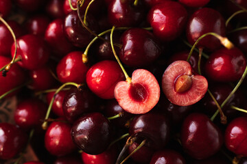 the cherry is close. a cut cherry berry with cuttings on top of other berries