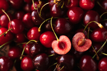 the cherry is close. a cut cherry berry with cuttings on top of other berries