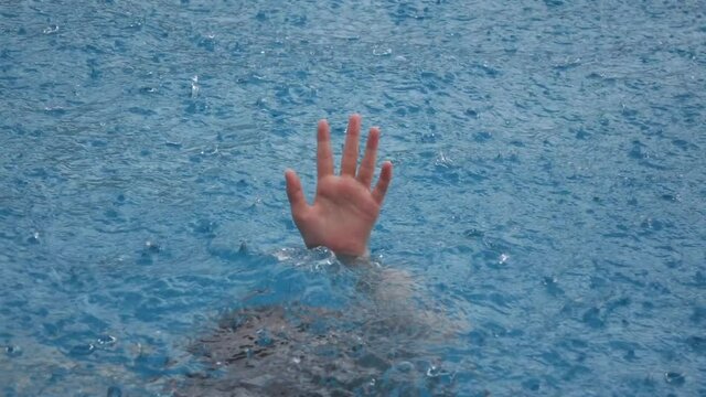 girl's hand drowning in the rain 