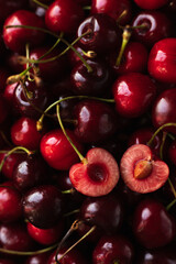 the cherry is close. a cut cherry berry with cuttings on top of other berries