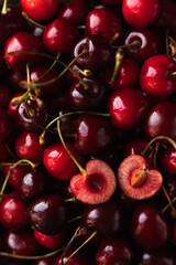 the cherry is close. a cut cherry berry with cuttings on top of other berries