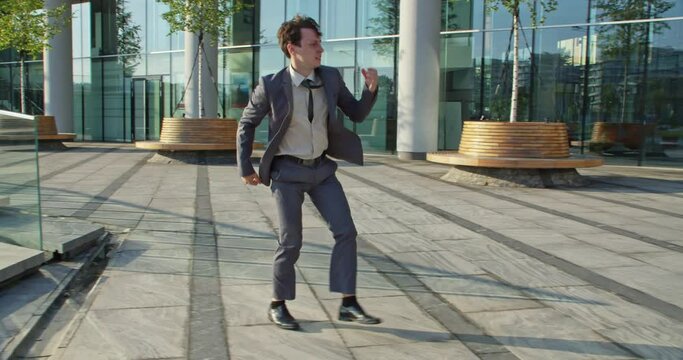 businessman jumps over himself and raises his hand up celebrating victory