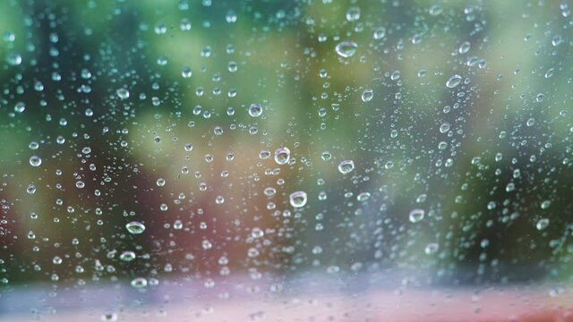 Rainy day behing the window in 4k slow motion 60fps