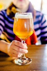 A girl drinks light beer in a bar
