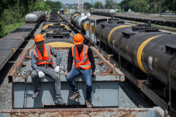 two worker sitting on top of bogie.