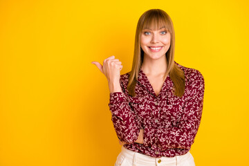 Photo portrait of young business woman smiling showing thumb empty space isolated bright yellow color background