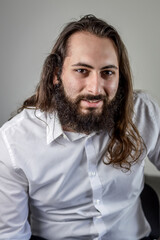 portrait of a young middle eastern businessman with beard and long hair