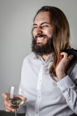 Profile portrait of a young middle eastern businessman with beard and long hair laughing cheerfully...