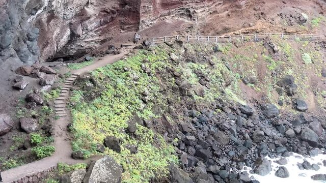 A young woman walking towards the Nogales beach, La Palma Island, Canary Islands. 4K UHD