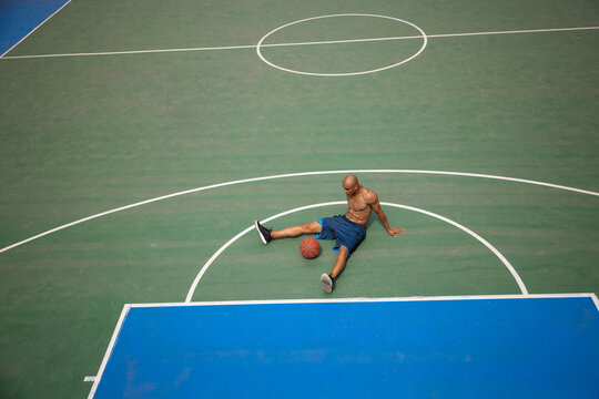 One african-american male basketball player playing at street public stadium, sport court or palyground outdoors. Concept of healthy active lifestyle, motion, hobby.