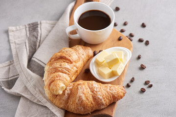 Delicious breakfast with fresh croissants and coffee served with butter