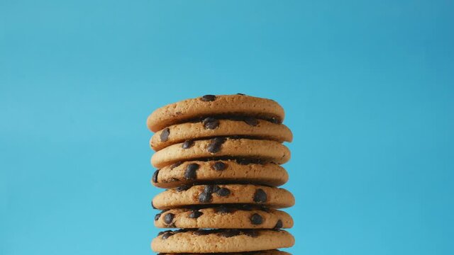 A stack of chocolate chip cookies sprout on a blue background. American cookies close up