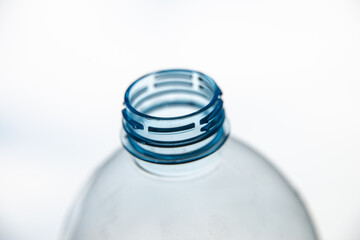 Transparent plastic bottles, on a clear surface. Transparent bottle neck. Recycling and disposal of...