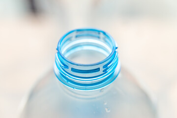 Transparent plastic bottles, on a clear surface. Transparent bottle neck. Recycling and disposal of...