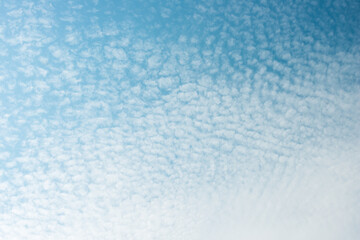 abstract sky background with near gradient clouds - or sheep-fleece clouds against as blue sky background