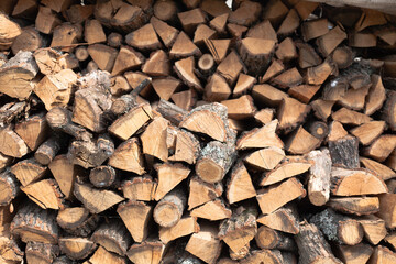Stacked firewood background. Firewood pattern. Wood saving wall. Natural materials background. Stock of wood for kindling a fireplace for the winter.