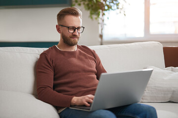 Man using laptop in living room