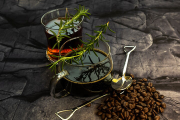 Hot black coffee and hot tea on dark stone background